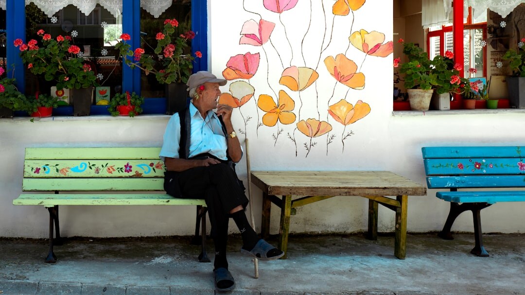 old man on bench in village